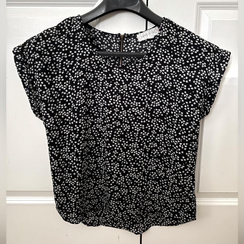 Black short sleeve blouse with little white flower detail, size small